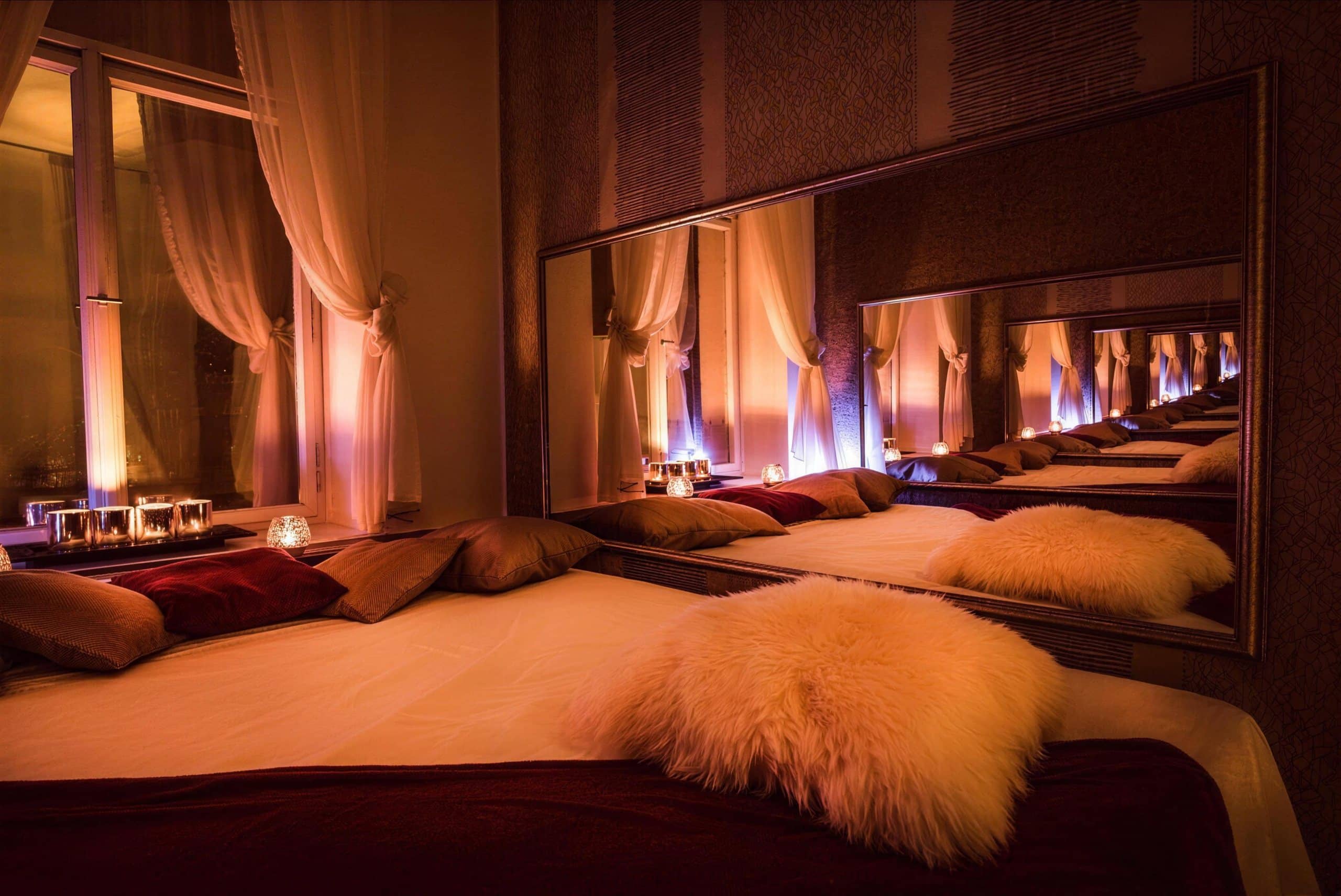 Candlelit massage room with a large mirror at Imperial salon in Prague 1